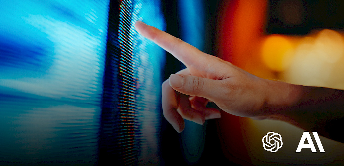 hand touching a glowing blue screen beside the OpenAI and Anthropic logo.