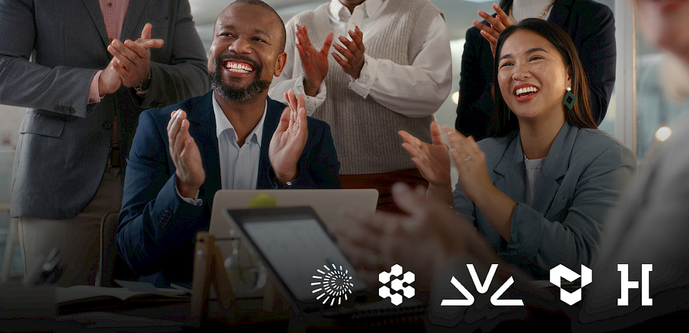 Colleagues applaud during a meeting above the Crusoe, Cognition, Fireworks AI, Tenstorrent and Hadrian logos.