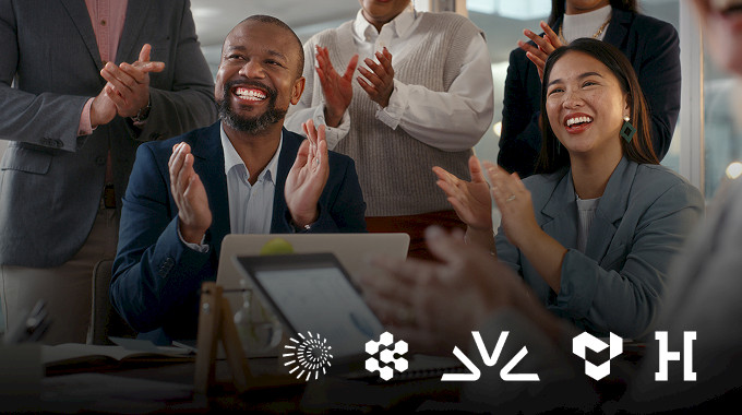 Colleagues applaud during a meeting above the Crusoe, Cognition, Fireworks AI, Tenstorrent and Hadrian logos.
